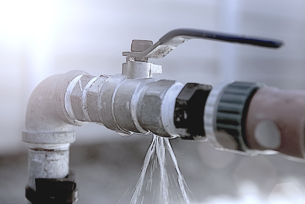 Image of a pipe leaking water.