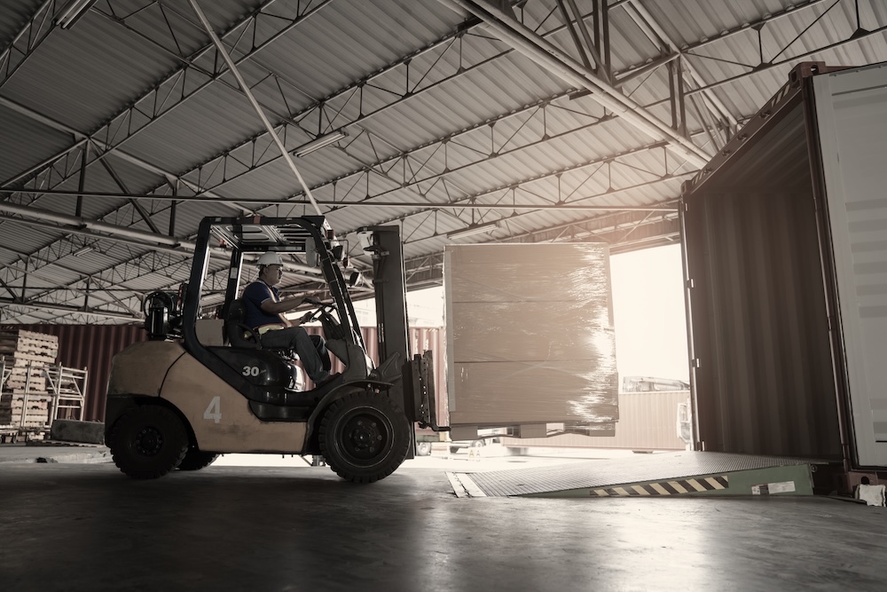 Image of the interior of a loading dock with a forklift.